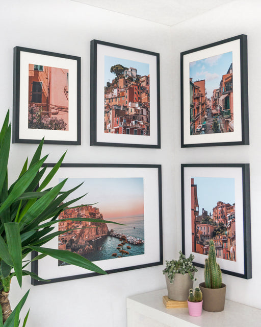 Soft pink and green-colored posters of Cinque Terre.
