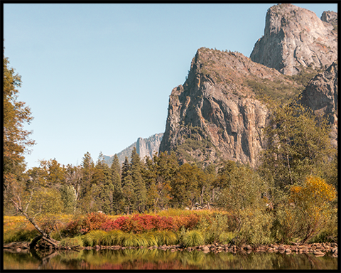 This poster features the Three Brothers rock formation in Yosemite National Park with surrounded by stunning fall colors. 