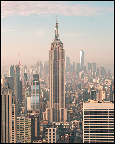 This New York City poster features an unobstructed view of the Empire State Building against a beautiful soft-colored sunrise sky. 